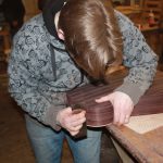 Ciaren using a scraper to clean up the sides