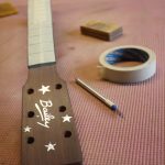 The fretboard is masked up
