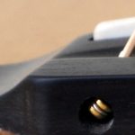Close up of the ebony pinless bridge