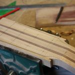 The headstock is marked out with a pencil