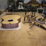 The fretboard is glued on and left to dry