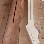 The neck is removed to reveal the truss rod slot