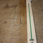 A straw is placed over the rod to prevent any glue getting on it