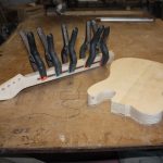 A fillet of wood is glued over the rod and held in place with spring clamps